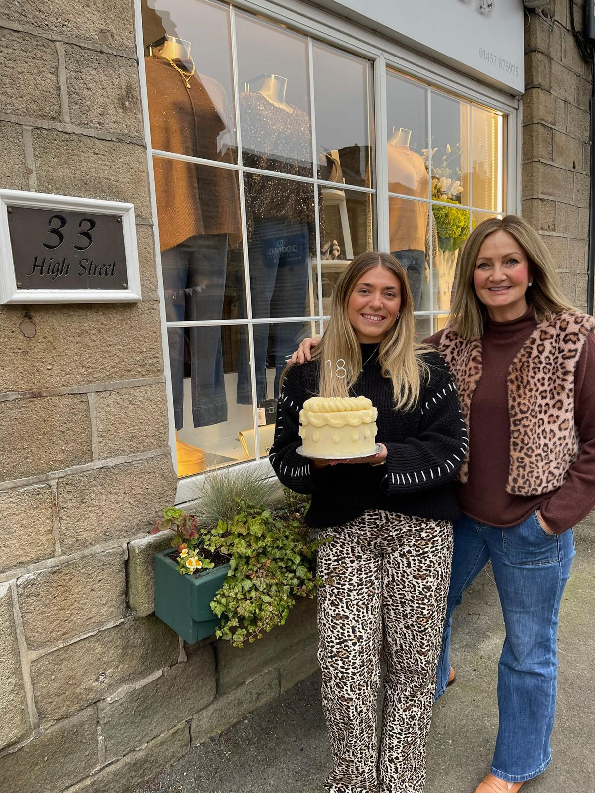 Hannah and Lucy celebrating outside the Lucy Cobb boutique in Uppermill