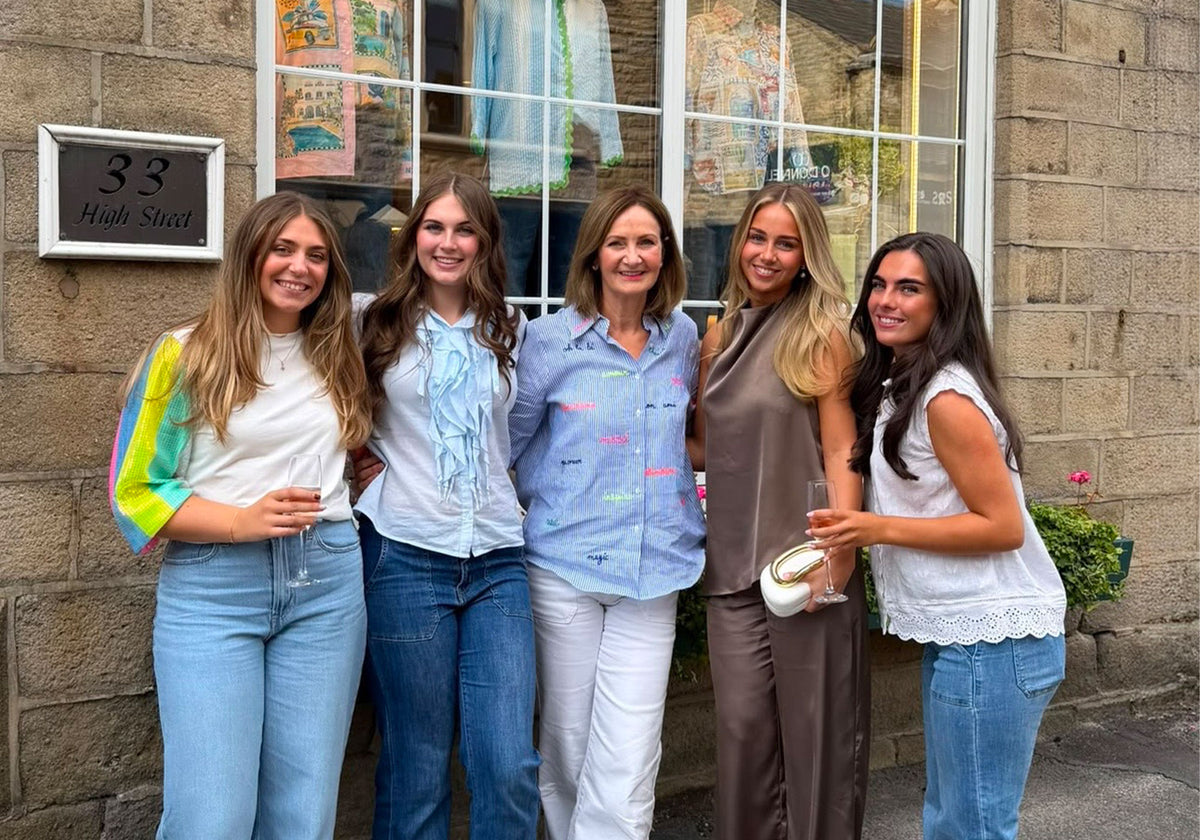 The Lucy Cobb Team celebrating in front of the boutique.