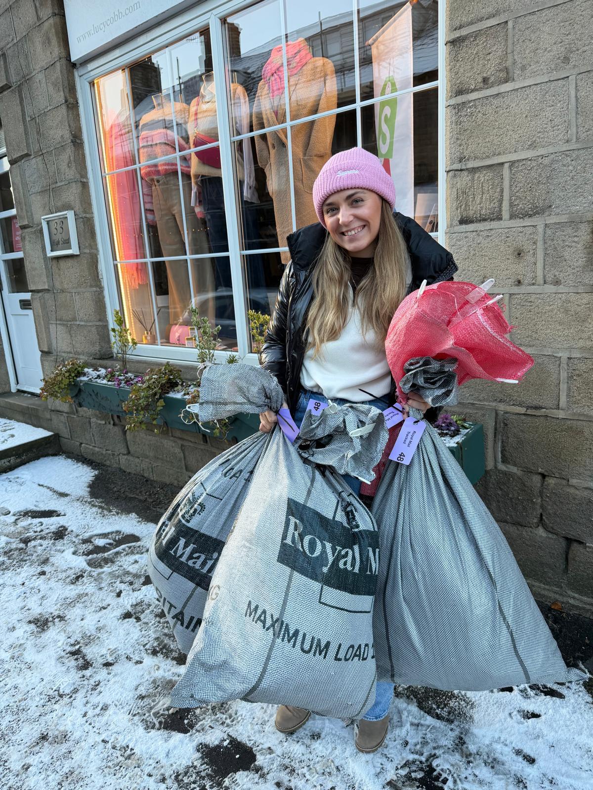 Hannah carrying customer parcels outside the Lucy Cobb boutique in winter