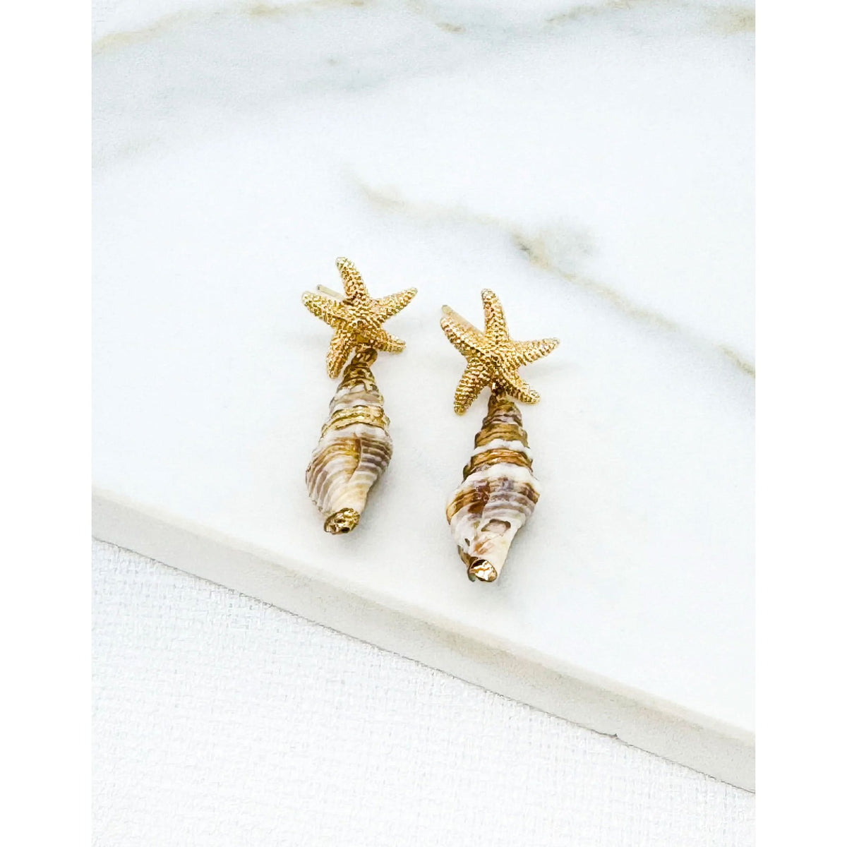 https://dknwnigc18uf4.cloudfront.net/product-media/U8B/1600/1600/star-and-shell-earrings-1-.jpg